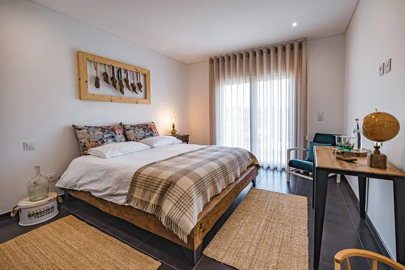 Holiday rental bedroom with a desk and travel-themed decoration