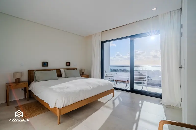 Bright holiday rental bedroom with a glass door to the outside